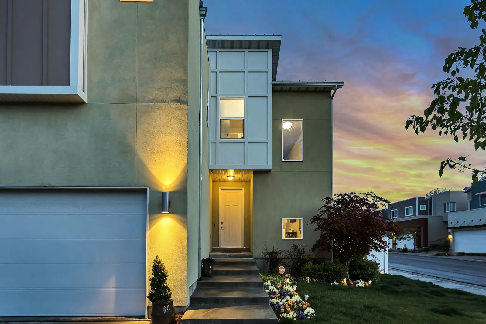 Sunlit, well-kept rental property exterior with landscaped grounds